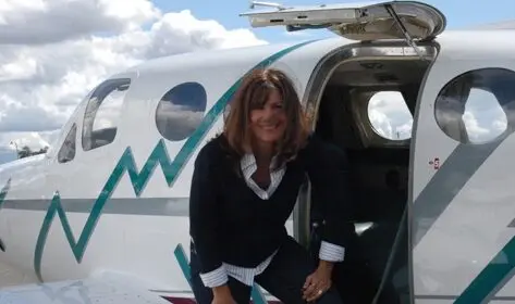 Smiling Woman Standing in the Aircraft